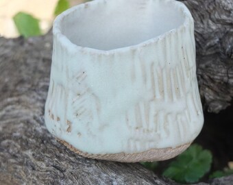 Pot embossed and glazed. Celadon. Bottom embossed, not enamelled