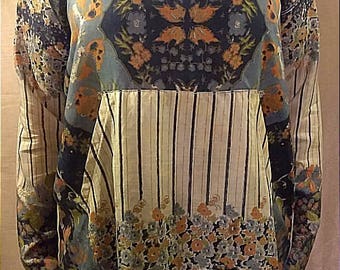 One-of-a-kind 100% up-cycled silk multi-patterned tunic featuring over-sized cowl neck and front pocket detail