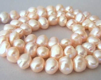 Pale peachy pink freshwater pearls, 10mm x 6mm, full strand, champagne, Silk color
