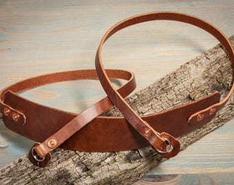 Chesnut leather copper riveted camera strap with fixed shoulder pad.