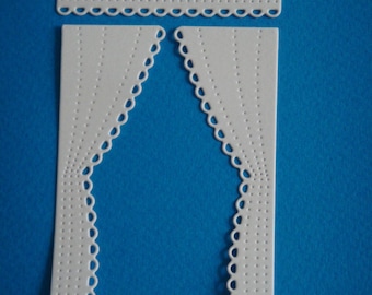 A pair of cutout white curtains for scrapbooking and card