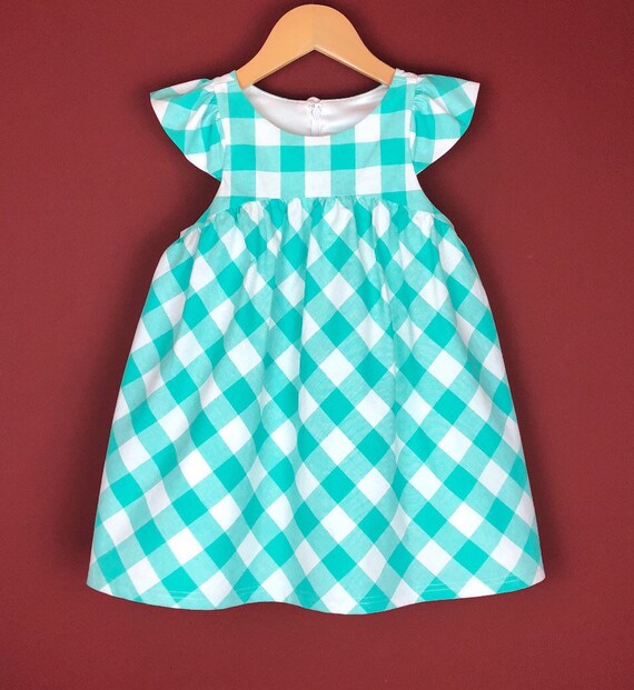 The "Flutter-By Dress" in Aqua Gingham.