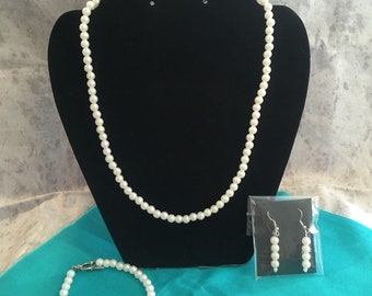 Traditional imitation white pearl necklace set.