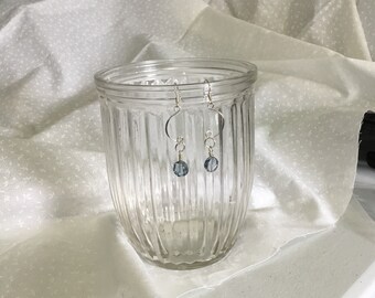 Sterling silver dangle earrings with a blue disc glass bead.