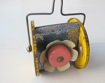 Vintage tin pull-along toy. Flower bells!