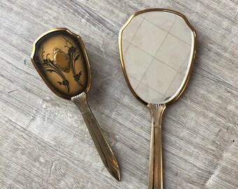 Antique hand mirror with brush