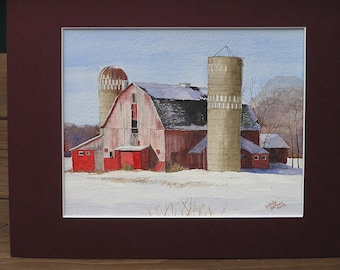 Red barn and two silos in Winter.