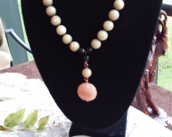 One strand designer necklace with center drop