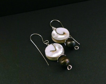 Sterling silver hand forged dangle earrings with swirling round mother of pearl composit beads.