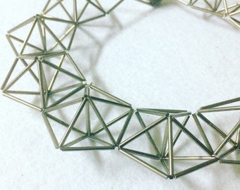Three dimensional pentagons necklace in glass tubes