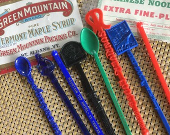 Eight vintage swizzle sticks with two old ephemera labels
