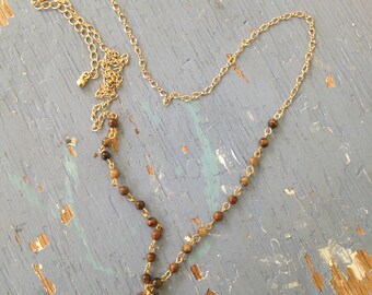 Gold Tone Necklace with Tortoise Beads and Glass Pendant