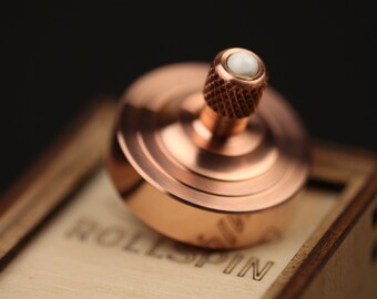 Precision Copper spinning top. Tungsten contact point & Ceramic anti-stress ball. Spin time 5-9 min. RollSpin (kickstarter). Edc pocket top.