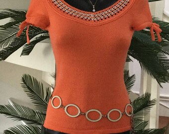 Crochet and jersey knit orange sweater