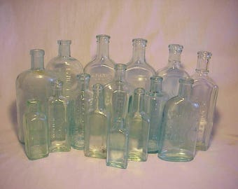 c1880s-1920s Collection of 15 Different Aqua Glass Embossed Cork Top Medicine, Bitters and Household Bottles No. 2