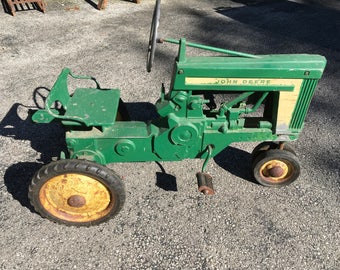 John Deere Eska Peddle tractor from 1950's with cart and umbrella material and umbrella pole. Accepting offers