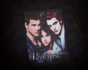 Hand-madeTwilight Eclipse throw pillow has Edward, Bella,Jacob. Back is solid black.