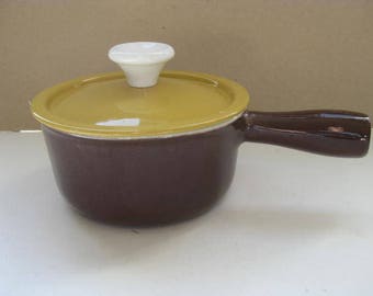DESCOWARE brown cast iron saucepan with a yellow lid.