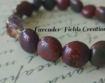 Red Picasso Lentil Beads with Aqua/Lavender Center Beads and a Carved Metal Focal piece. (201762B)