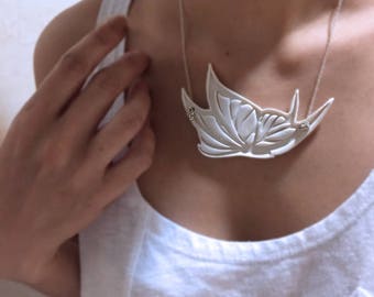 A delicate porcelain pendant with chain