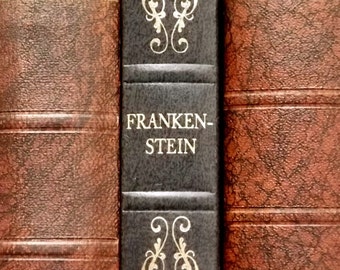 Frankenstein vintage book by Mary Shelley with faux leather binding in dark blue.