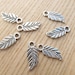 Set of 10 charms shaped small Tibetan style metal leaves.