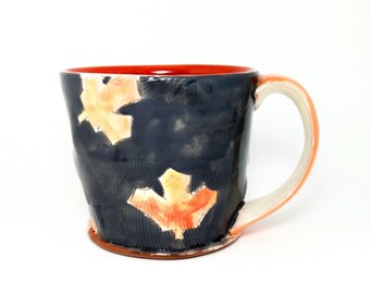 Grey maple leaf themed Earthenware mug. Wheel thrown, food safe leafy mug made by Kaitlyn Brennan