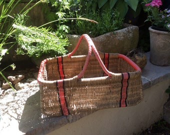 Original vintage 1950s wicker shopping basket red and black trim.