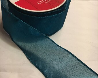 Teal shimmering ribbon w/wired edge 2.5 inches wide, each roll is 25 ft. long
