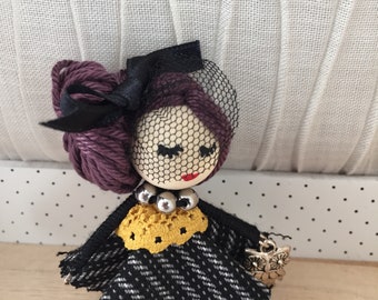 Doll brooch.
