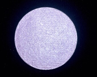 Shade name ( Down Under ). Violet lavender highlighter. Smooth, rich texture. Vegan and cruelty free. Size and compact options available.
