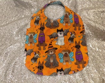 Orange Halloween costumed dog baby bib with aqua back