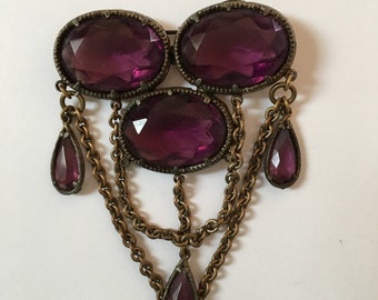 Vintage brooch with purple glass stones