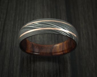 Damascus steel and 14k rose gold band with desert ironwood burl sleeve custom made