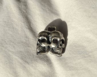 Siamese twin skull pendant
