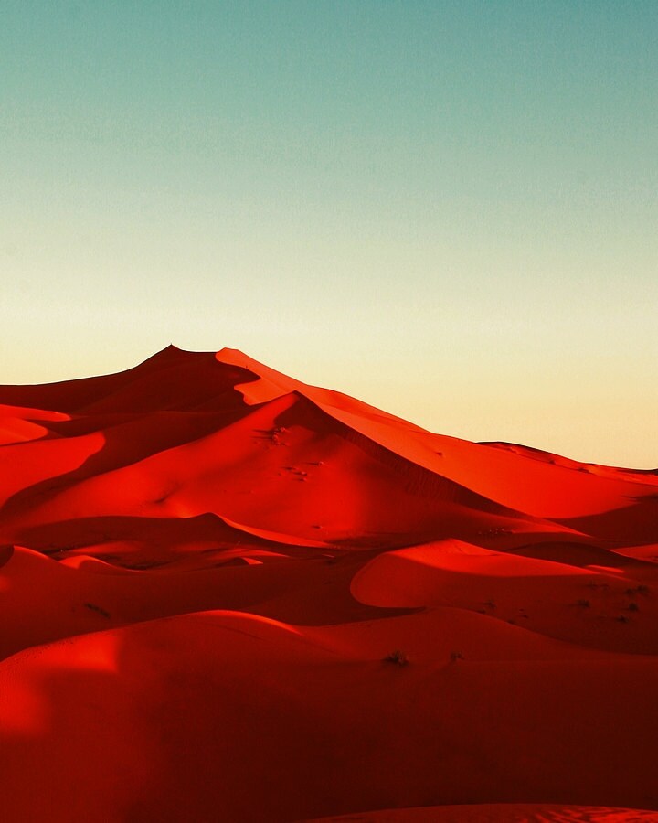 Red desert Morocco sand dunes blue sky sunshine shadows retro