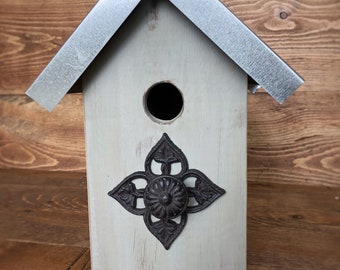 Outdoor country birdhouse with metal roof and rustic metal knob