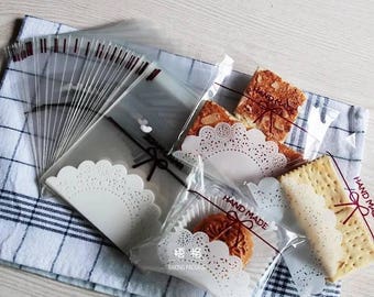 JParadise - 50/100 Pcs Lace Ribbon Self Adhesive Plastic Cookie Bag Candy Bag Pastry Bag Gift Bag PLUS Decorative Stickers
