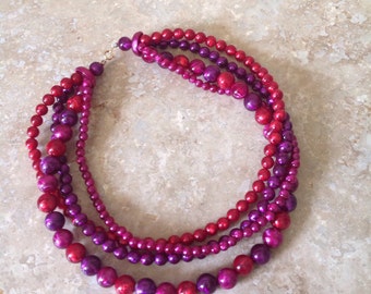 Red and magenta 4 strand necklace.
