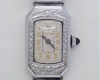 A vintage Bulova ladies watch, incised decorative case, art deco gild Arabic white dial