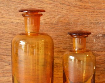 2 light brown pharmacy bottles with cut stopper