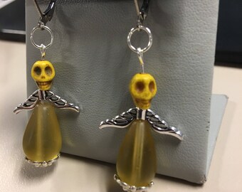Yellow earrings with skulls