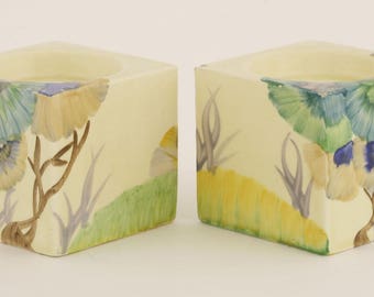 A pair of Clarice Cliff Bizarre 'Rhodanthe' candle holders, printed and moulded marks, 6cm high