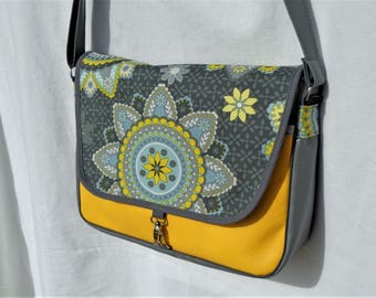 Leatherette grey and yellow, fabric satchel "rosettes" on the flap.