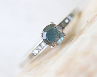 Labradorite and silver cocktail ring with pave set diamonds on either side of the main gem