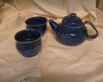 cobalt blue two cup teapot with two matching tea bowls.