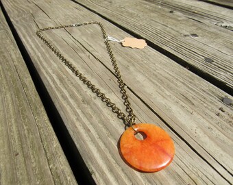 Groovy orange circle pendant necklace on bronze chain
