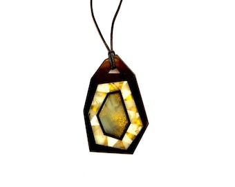 Pendant of amber and Gagat in abstract style