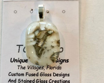 Fused glass pendant with silver inclusions