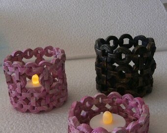 Lanterns with candles in recycled paper stack